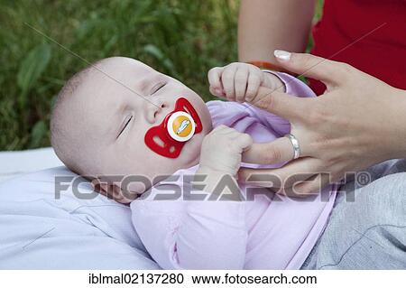 A few months old baby clinging to the fingers of its mother View Large Photo Image Stock Image - A few months old baby clinging to the fingers of its mother. Fotosearch