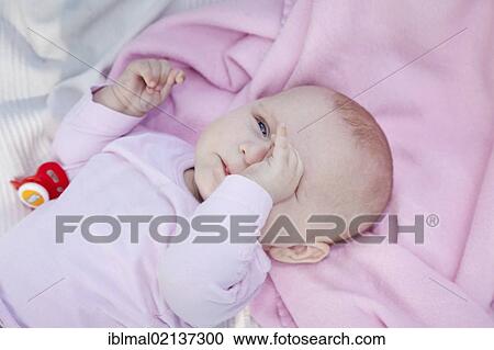 A few months old baby rubbing its eye View Large Photo Image Stock Image - A few months old baby rubbing its eye. Fotosearch