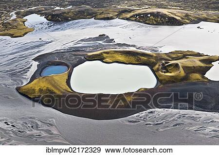 Aerial view of a volcano, moss and red minerals on the slopes shining in the sunlight, the extinct craters are filled with coloured water, the volcano is located between the waterways of the Tungna River and Lake Langisjoer, between Landmannalaugar... View Large Photo Image Stock Photo - Aerial view of a volcano, moss and red minerals on the slopes shining in the sunlight, the extinct craters are filled with coloured water, the volcano is located between the waterways of the Tungna River and Lake Langisjoer, between Landmannalaugar.... Fotosearch