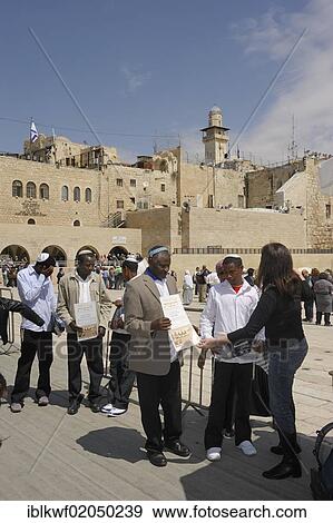 Stock Photo - African Jews receiving a certificate from a Jewish woman that they visited the Western or Wailing Wall, Muslim Quarter, Old City, Jerusalem, Israel, Middle East, Asia. Fotosearch