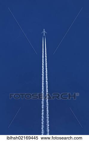 Airplane with double contrails in the blue sky View Large Photo Image Stock Photography - Airplane with double contrails in the blue sky. Fotosearch