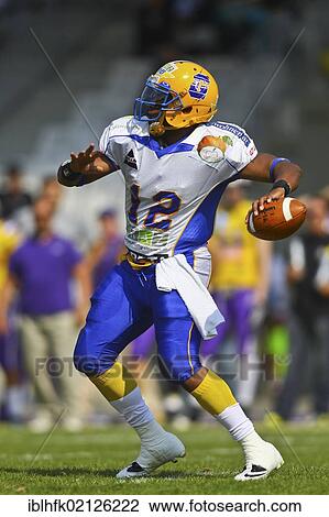 Stock Image - American Football, QB Chris Gunn, No. 12 of Giants, passing the ball; Vienna Vikings win against Graz Giants 19: 14, Vienna, Austria, Europe. Fotosearch