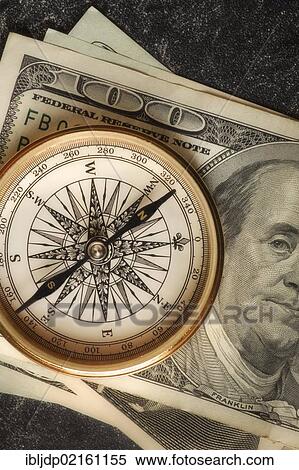 Antique gold compass on an array of US dollars, symbolic image for financial planning View Large Photo Image Stock Photography - Antique gold compass on an array of US dollars, symbolic image for financial planning. Fotosearch