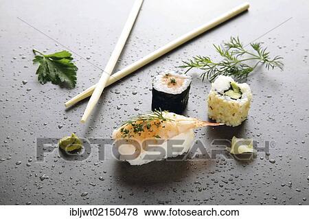 Stock Photo - Assorted sushi with ginger and wasabi on a stone surface. Fotosearch
