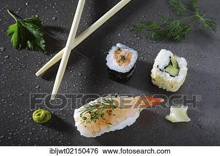 Stock Photograph - Assorted sushi with ginger and wasabi on a stone surface. Fotosearch