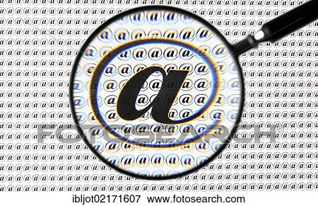 At symbol, @, through a magnifying glass View Large Photo Image Stock Photo - At symbol, @, through a magnifying glass. Fotosearch