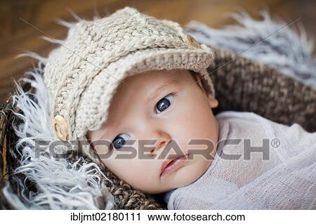 Baby, 2 months, wearing a knitted cap and lying in a basket View Large Photo Image Stock Image - Baby, 2 months, wearing a knitted cap and lying in a basket. Fotosearch