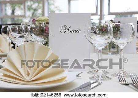 Banquet, dinner table, table decorated for a celebration with a menu card View Large Photo Image Stock Photograph - Banquet, dinner table, table decorated for a celebration with a menu card. Fotosearch