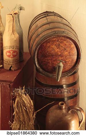 Stock Image - Barrels, can and Akvavit bottles wrapped in paper, Aalborg Akvavit spirits factory, Aalborg, North Jutland, Denmark, Europe. Fotosearch
