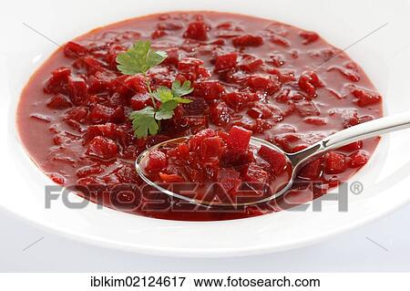 Stock Photo - Borscht, Russian, Ukrainian stew from a can, on a white plate and spoon. Fotosearch