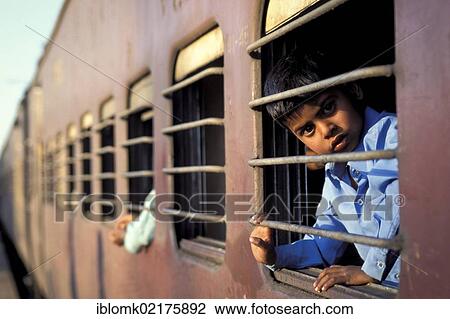 Boy looking out of a train compartment, New Delhi Railway Station, New Delhi, India, Asia View Large Photo Image Stock Image - Boy looking out of a train compartment, New Delhi Railway Station, New Delhi, India, Asia. Fotosearch