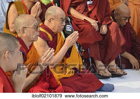 Stock Photo - Buddhism, the Dalai Lama in a communal prayer with dignitaries, eg Karamapa, from all Buddhist branches and schools, gathering for meditation in Gandhi Smitri, Global Buddhist Congregation 2011, New Delhi, India, Asia. Fotosearch