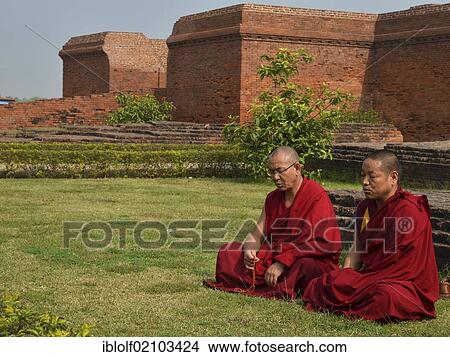Buddhism, Tibetan monks in red robes in meditation and prayer during the pilgrimage at the archaeological site of the ancient university of Nalanda, Global Buddhist Congregation 2011, Ragir, Bihar, India, Asia View Large Photo Image Picture - Buddhism, Tibetan monks in red robes in meditation and prayer during the pilgrimage at the archaeological site of the ancient university of Nalanda, Global Buddhist Congregation 2011, Ragir, Bihar, India, Asia. Fotosearch