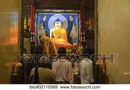 Buddhist pilgrims and visitors inside the sacred Mahabodhi Temple, with the Buddha statue next to which Siddhartha Gautama, the historic Buddha, gained awakening, Bodhi, Bodhgaya, Bihar, India, Asia View Large Photo Image Stock Photo - Buddhist pilgrims and visitors inside the sacred Mahabodhi Temple, with the Buddha statue next to which Siddhartha Gautama, the historic Buddha, gained awakening, Bodhi, Bodhgaya, Bihar, India, Asia. Fotosearch