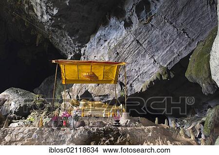 Picture - Buddhist shrine in the Tham Poukham Cave, stalactite or limestone cave in karst rock formations, Vang Vieng, Vientiane, Laos, Indochina, Asia. Fotosearch