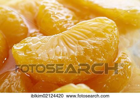 Stock Image - Canned mandarin pieces, closeup. Fotosearch