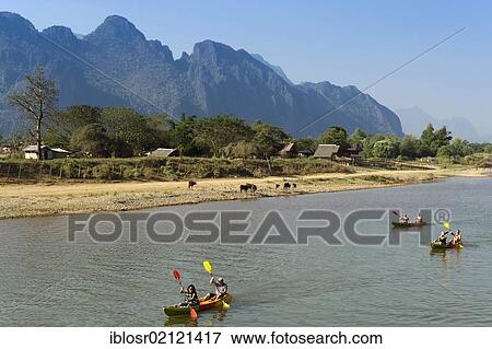 Stock Photo - Canoeing on the Nam Song River, karst mountains at back, Vang Vieng, Vientiane, Laos, Indochina, Asia. Fotosearch