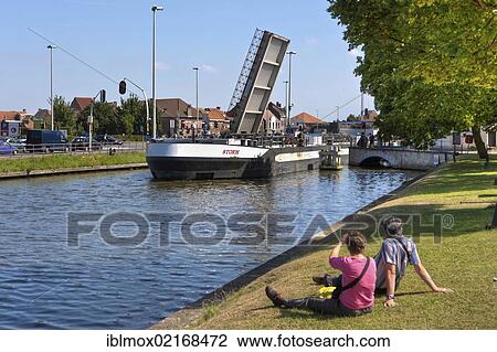 Cargo shipping passing a movable bridge, Vlaanderen Fietsroute, Flanders Bike Trail, at the Coupure Canal, Bruges, West Flanders, Flemish Region, Belgium, Europe View Large Photo Image Stock Image - Cargo shipping passing a movable bridge, Vlaanderen Fietsroute, Flanders Bike Trail, at the Coupure Canal, Bruges, West Flanders, Flemish Region, Belgium, Europe. Fotosearch