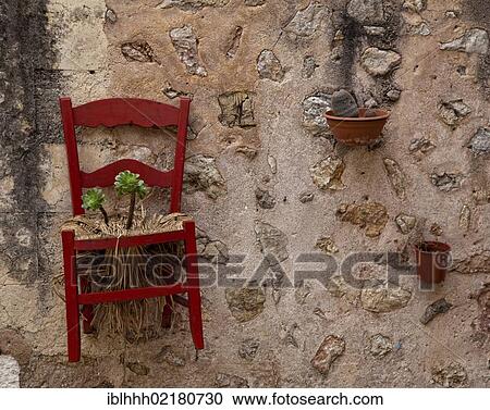 Chair with a flower growing from it on a wall, Valldemossa, Majorca, Balearic Islands, Spain, Europe View Large Photo Image Stock Image - Chair with a flower growing from it on a wall, Valldemossa, Majorca, Balearic Islands, Spain, Europe. Fotosearch