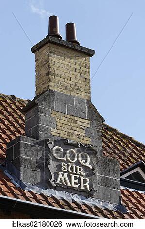 Stock Photograph - Chimney with lettering Coq sur Mer, tram station built in an Art Nouveau style, De Haan, West Flanders, Belgium, Europe. Fotosearch