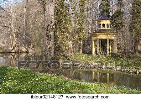 Chinese Pavilion reflected in the castle pond, Spring Snowflakes blossoming in the Jahnishausen castle grounds near Riesa, river Jahna, in spring, Saxony, Germany, Europe View Large Photo Image Stock Photo - Chinese Pavilion reflected in the castle pond, Spring Snowflakes blossoming in the Jahnishausen castle grounds near Riesa, river Jahna, in spring, Saxony, Germany, Europe. Fotosearch