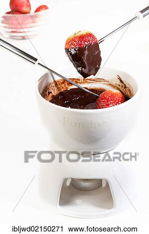 Stock Image - Chocolate fondue with strawberries. Fotosearch