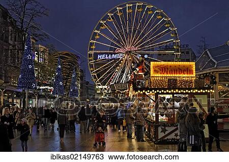 Stock Image - Christmas market with a ferris wheel at night, Koenigsstrasse street, Duisburg, North Rhine-Westphalia, Germany, Europe. Fotosearch