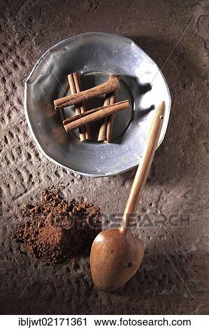 Cinnamon sticks (Cinnamomum) on a metal plate with a wooden spoon and cinnamon powder on a rustic stone base View Large Photo Image Stock Image - Cinnamon sticks (Cinnamomum) on a metal plate with a wooden spoon and cinnamon powder on a rustic stone base. Fotosearch