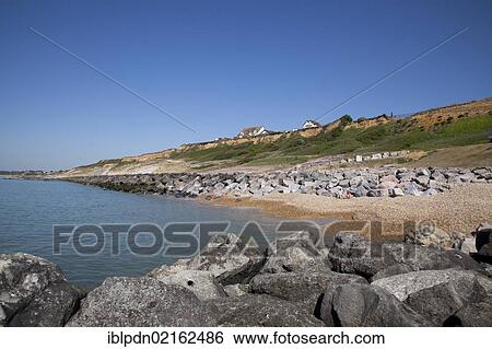Cliff top houses and rock stone groynes sea defences at Barton on Sea, Hampshire, England, United Kingdom, Europe View Large Photo Image Stock Photograph - Cliff top houses and rock stone groynes sea defences at Barton on Sea, Hampshire, England, United Kingdom, Europe. Fotosearch