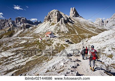 Stock Photograph - Climber ascending Paternkofel Pass, facing the Three Peaks Hut and the Toblinger Nodes, Sesto, Alta Pusteria, Dolomites, Alto Adige, Italy, Europe. Fotosearch
