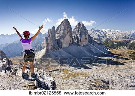 Stock Photo - Climber on Paternkofel Mountain overlooking the Three Peaks, with Monte Cristallo at the rear, Alta Pusteria, Sesto, Dolomites, Alto Adige, Italy, Europe. Fotosearch