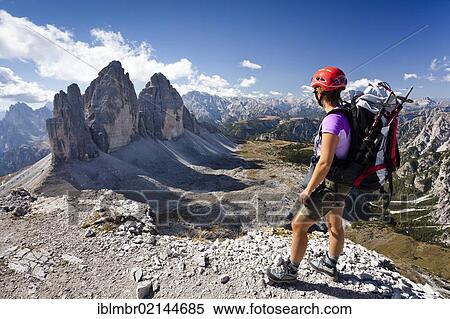 Stock Photography - Climber on the Paternkofel Pass, facing the Tre Cime di Lavaredo or Three Peaks, with Monte Cristallo behind, Sesto, Alta Pusteria, Dolomites, Alto Adige, Italy, Europe. Fotosearch
