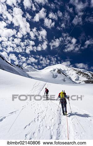 Stock Photograph - Climbers ascending Piz Palu through the glacier landscape, behind the summit of Piz Palu, Grisons, Switzerland, Europe. Fotosearch