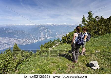 Climbers during the ascent to Monte Altissimo above Nago, overlooking Lake Garda and Arco, Trentino, Italy, Europe View Large Photo Image Stock Photo - Climbers during the ascent to Monte Altissimo above Nago, overlooking Lake Garda and Arco, Trentino, Italy, Europe. Fotosearch