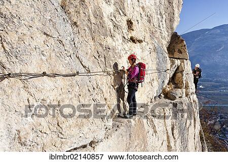 Climbers during the ascent to Monte Albano on the fixed rope trail above Mori, Lake Garda hills, Rovereto, Trento, Italy, Europe View Large Photo Image Stock Photo - Climbers during the ascent to Monte Albano on the fixed rope trail above Mori, Lake Garda hills, Rovereto, Trento, Italy, Europe. Fotosearch