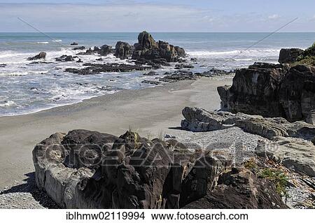 Picture - Coastal landscape with rocks and a sandy beach south of Punakaiki, Highway 6, Tasman Sea, West Coast, South Island, New Zealand, Oceania. Fotosearch