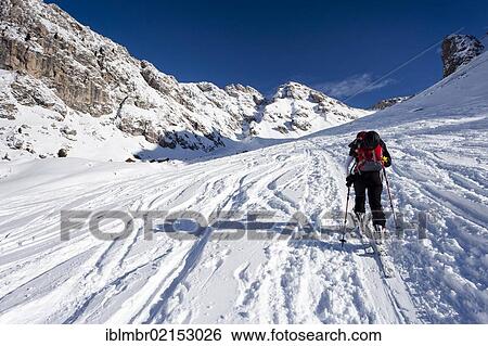 Cross-country skier above Woerndle-Loch-Alm alpine pasture while ascending Zendleser Kofel Mountain in the Villnoess Valley above Zanser Alm alpine pasture, Alto Adige, Italy, Europe View Large Photo Image Stock Photograph - Cross-country skier above Woerndle-Loch-Alm alpine pasture while ascending Zendleser Kofel Mountain in the Villnoess Valley above Zanser Alm alpine pasture, Alto Adige, Italy, Europe. Fotosearch