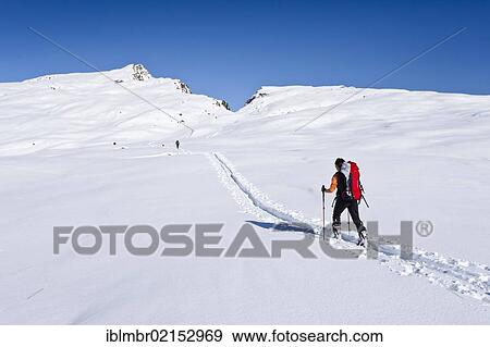 Cross-country skier ascending Cima Bocche Mountain above the Passo Valles Pass, looking towards Cima Bocche Mountain, Dolomites, Trentino, Italy, Europe View Large Photo Image Stock Photo - Cross-country skier ascending Cima Bocche Mountain above the Passo Valles Pass, looking towards Cima Bocche Mountain, Dolomites, Trentino, Italy, Europe. Fotosearch