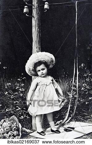 Cute little girl standing on a letter with a bunch of flowers, historical postcard, circa 1900, kitsch View Large Photo Image Stock Photo - Cute little girl standing on a letter with a bunch of flowers, historical postcard, circa 1900, kitsch. Fotosearch