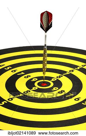 Stock Photo - Darts, throwing game, dart sticking into the middle of the dartboard, the bullseye. Fotosearch