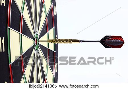 Stock Photography - Darts, throwing game, dart sticking into the middle of the dartboard, the bullseye. Fotosearch