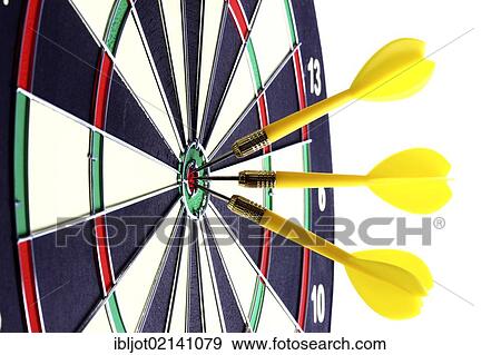 Stock Photo - Darts, throwing game, darts sticking into the middle of the dartboard, the bullseye. Fotosearch