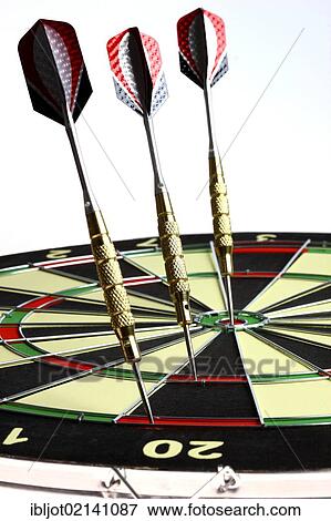 Stock Photo - Darts, throwing game, darts sticking into the double and triple score grids and the middle of the dartboard, the bullseye. Fotosearch