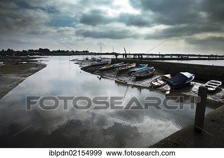 Stock Photo - Dramatic sky and reflection in still water at low tide, Emsworth harbour, Chichester Harbour, England, United Kingdom, Europe. Fotosearch
