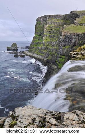 Stock Image - Drifandi waterfall, Drifandisbjarg, east coast of Hornstrandir, Westfjords, Iceland, Europe. Fotosearch