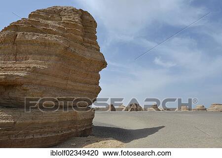 Stock Image - Dry desert landscape with rock formations, historic Silk Road, Yumen Pass, Yadan National Park, Gansu, China, Asia. Fotosearch