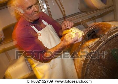Stock Photo - Farmer Giuseppe Tomasino producing butter, Rifugio Salvin, Lanzo, Piedmont, Italy, Europe. Fotosearch