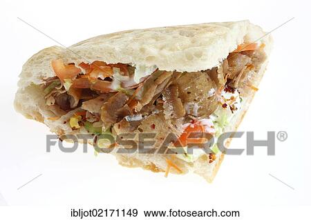 Fast food, doner kebab in pita bread with mixed salad and garlic-yogurt sauce View Large Photo Image Stock Photo - Fast food, doner kebab in pita bread with mixed salad and garlic-yogurt sauce. Fotosearch