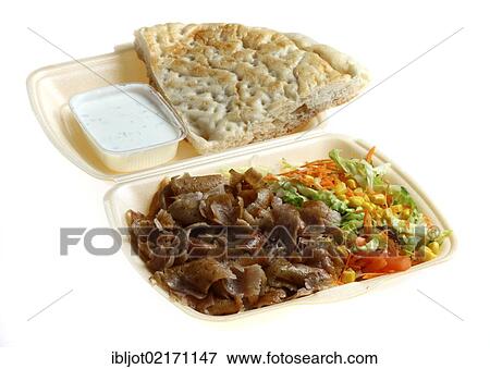 Fast food, doner kebab plate, with doner meat, salad, garlic-yogurt sauce and pita bread in plastic takeaway packaging View Large Photo Image Stock Photo - Fast food, doner kebab plate, with doner meat, salad, garlic-yogurt sauce and pita bread in plastic takeaway packaging. Fotosearch