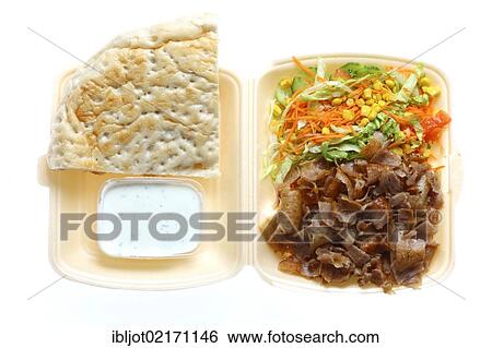 Fast food, doner kebab plate, with doner meat, salad, garlic-yogurt sauce and pita bread in plastic takeaway packaging View Large Photo Image Stock Photograph - Fast food, doner kebab plate, with doner meat, salad, garlic-yogurt sauce and pita bread in plastic takeaway packaging. Fotosearch